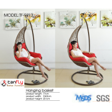 Hanging wicker pod swing chair with full cushion.